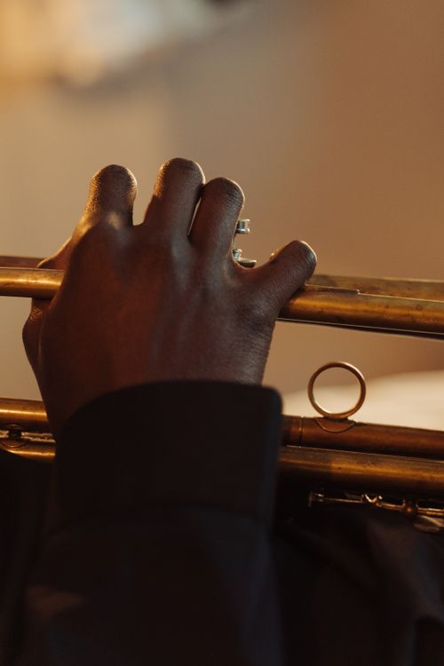Free A close-up view of a musician playing a trumpet with blurred background focus. Stock Photo