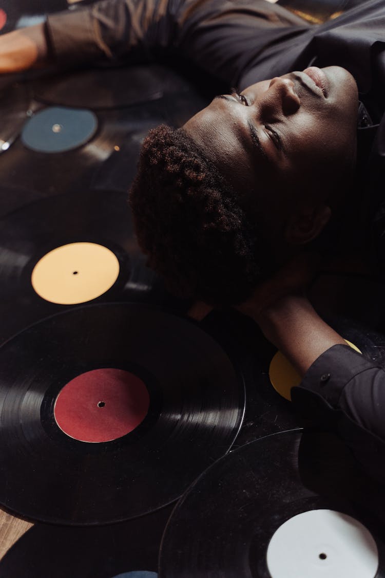 Man Lying On Vinyl Records