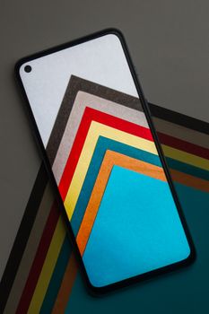Smartphone mockup with layers of colorful paper for design presentations, offering vibrant visuals.