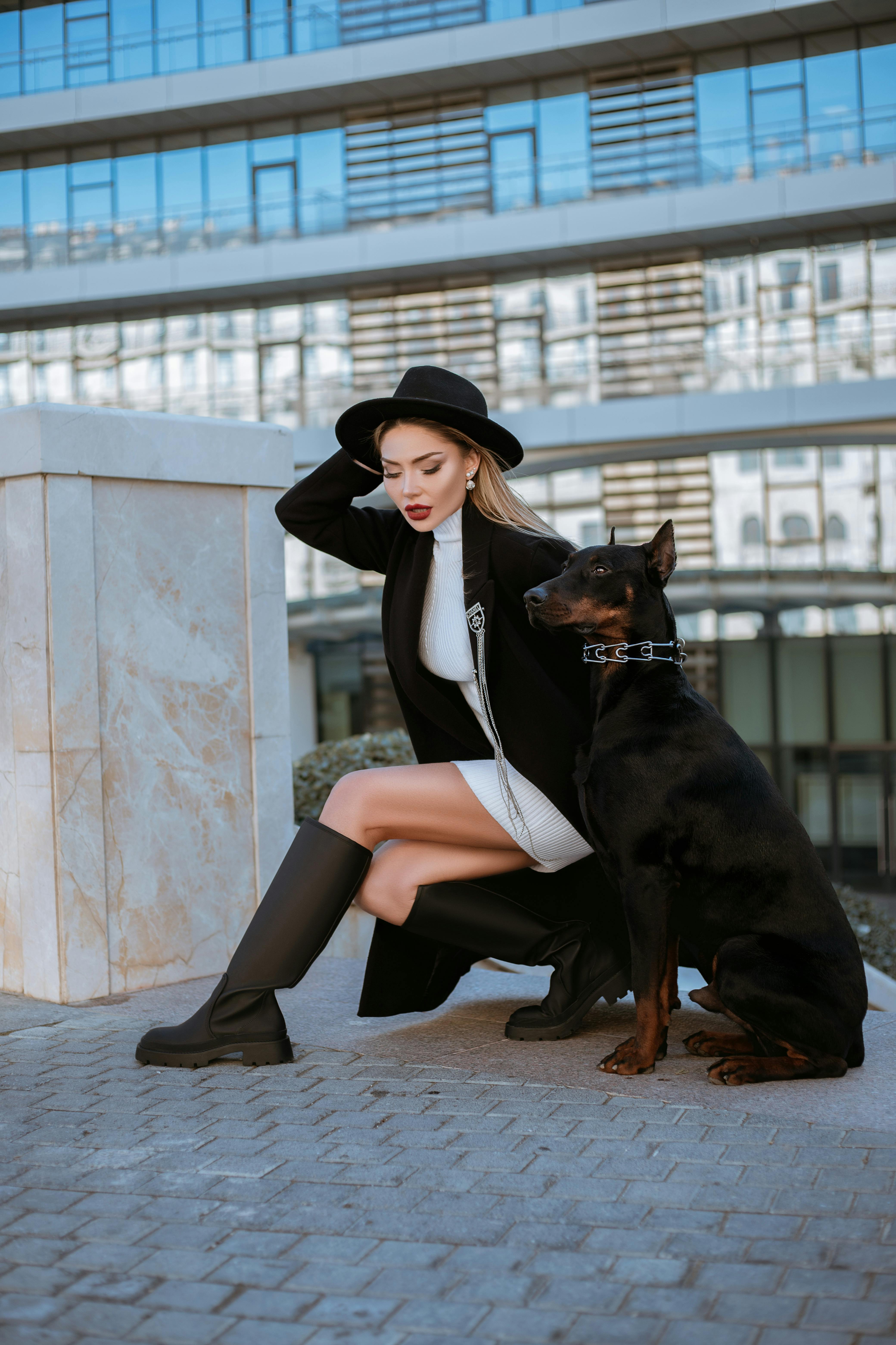 A Woman in a Stylish Outfit Posing with her Dog