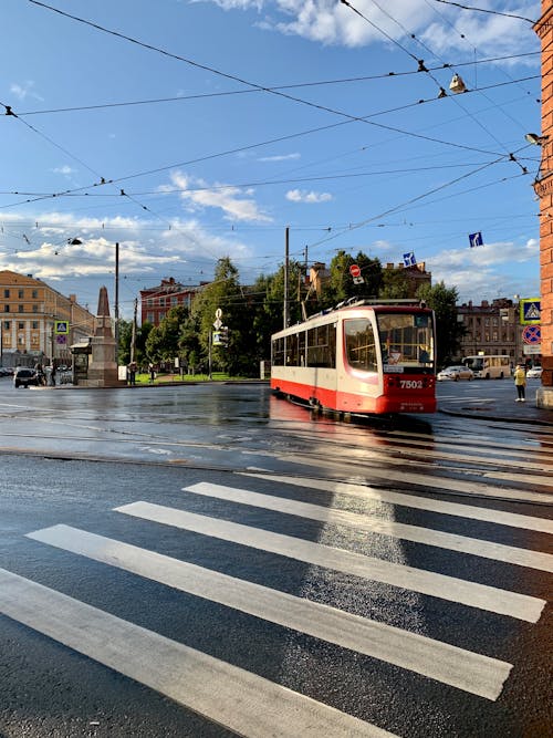 Red and White Tram on Road