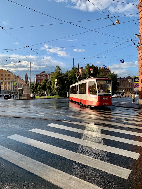 Red and White Tram on Road