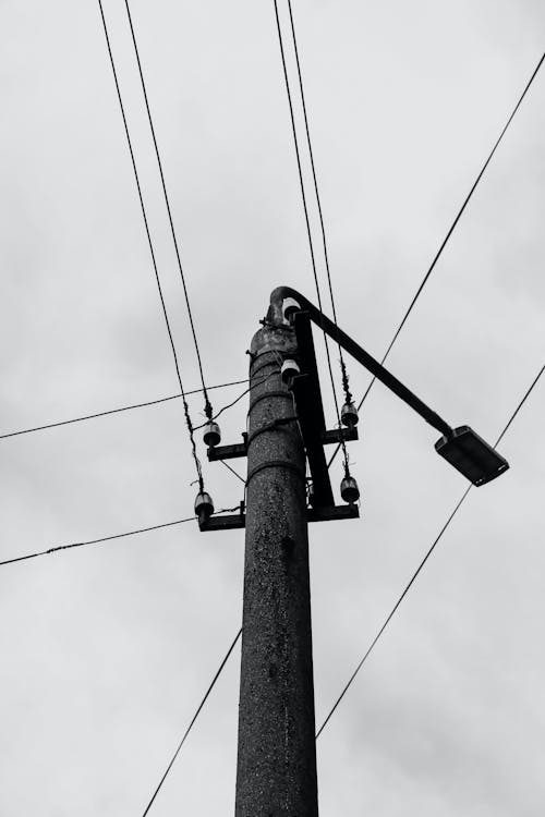 Grayscale Photo of an Electric Post