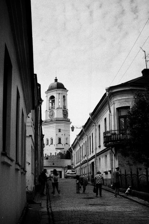 People Walking on the Road in Front of the Clock Tower