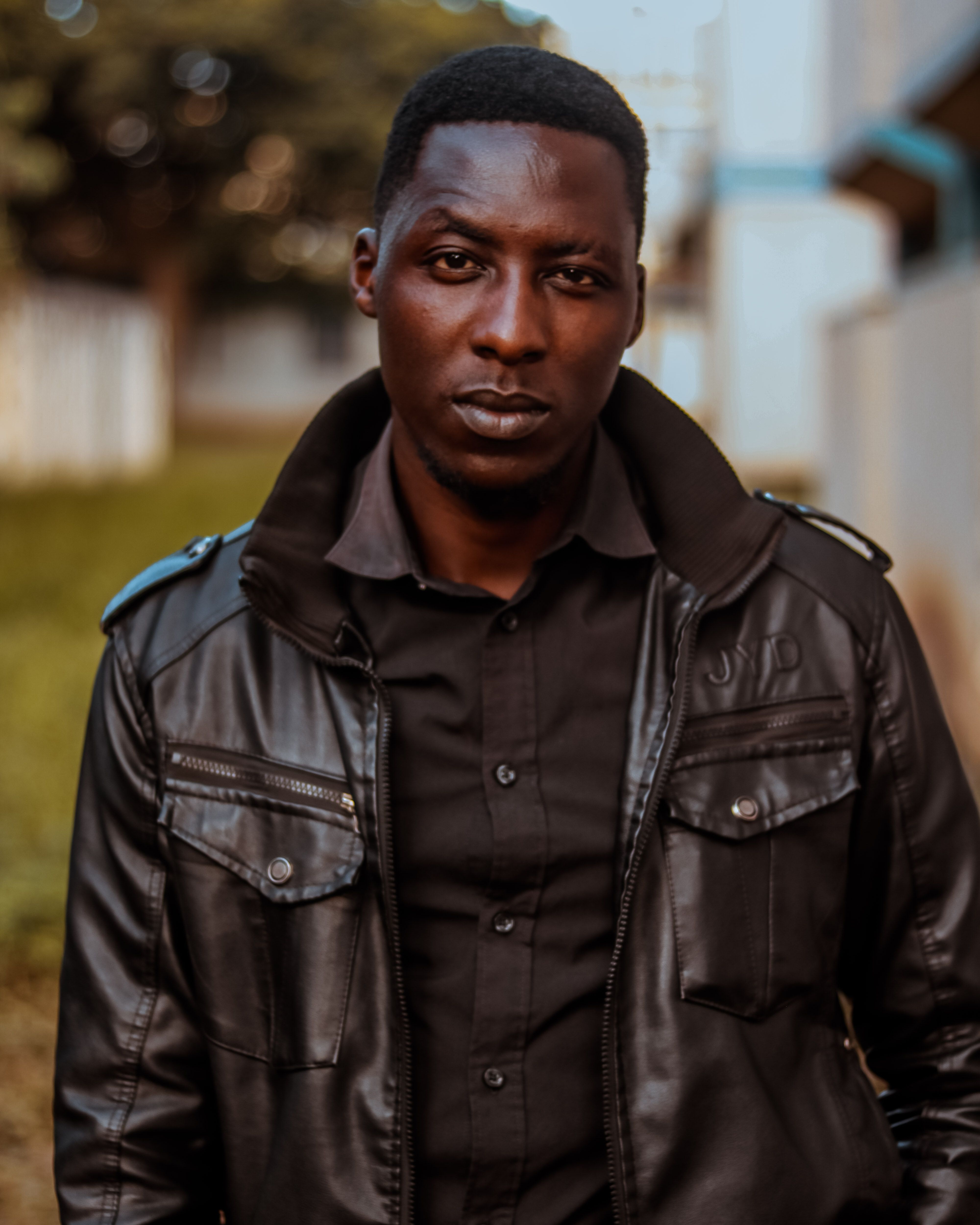 Close-up portrait of a man wearing a black leather jacket, showcasing fashion and style.