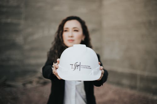 A Woman Holding White Hard Hat
