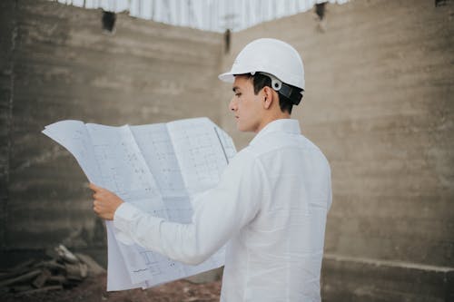 Male Architect looking at a Plan Layout 