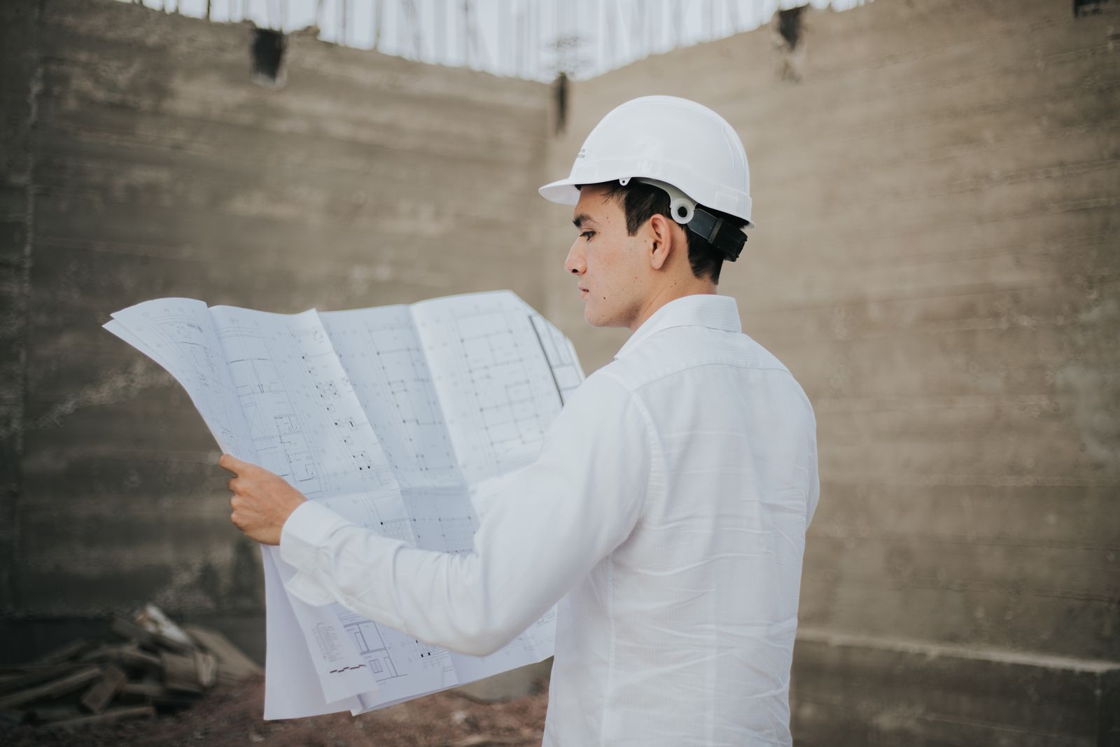 Contractor reviewing building plans at a construction site