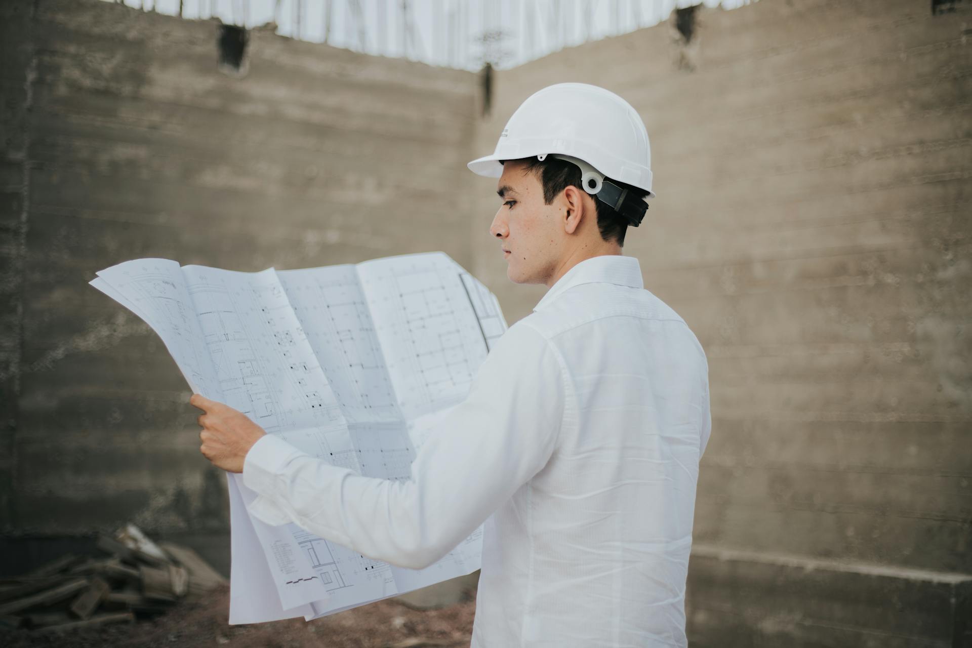 Male Architect looking at a Plan Layout