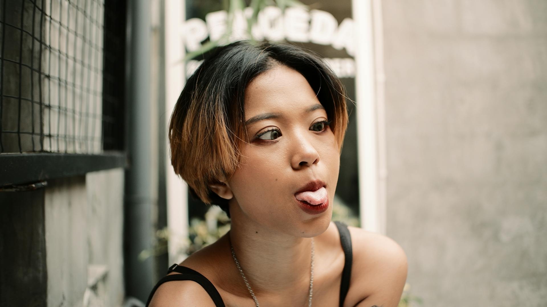 A Young Woman Sticking Her Tongue Out with Crossed Eyes