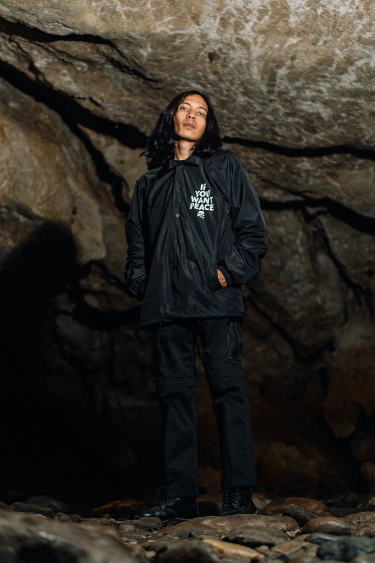 A Man Standing Inside Cave