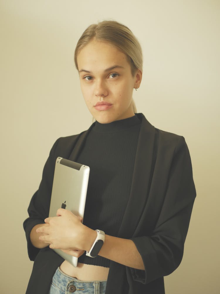 A Woman In Black Blazer Holding An Apple IPad