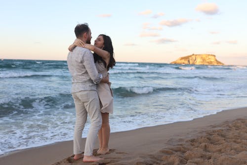 Free Couple Hugging on the Beach Stock Photo