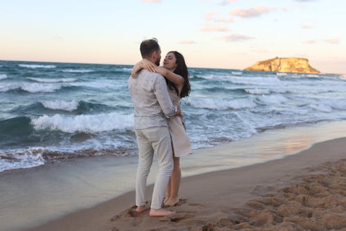 Free A Couple Hugging on the beach Stock Photo