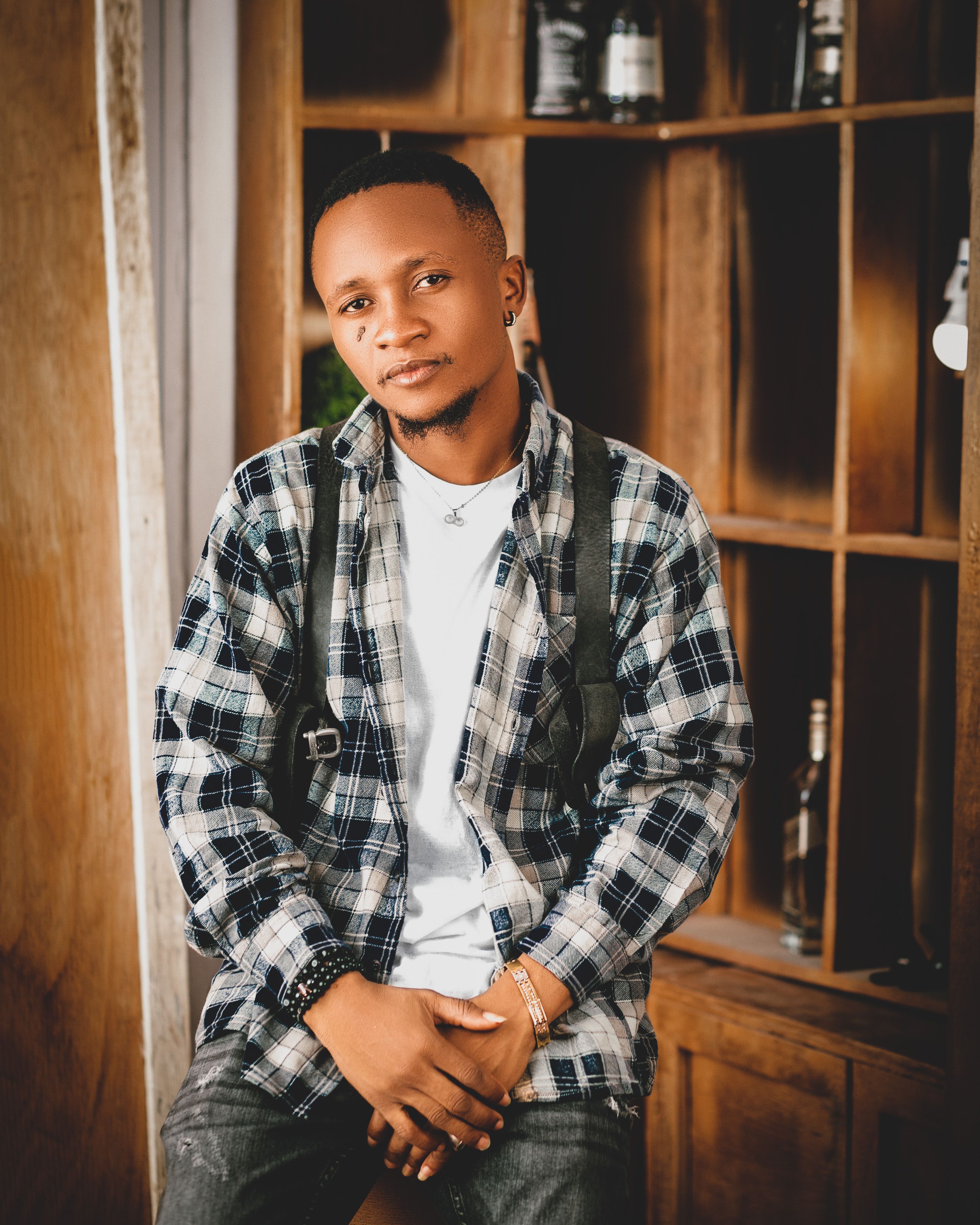Portrait of a fashionable young man posing confidently indoors in Nigeria.