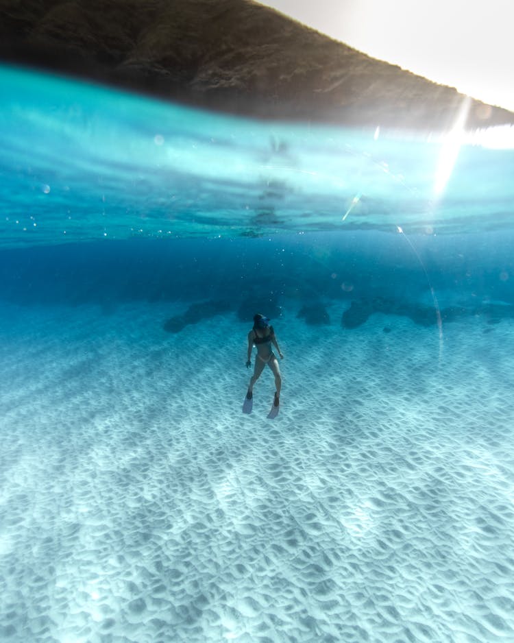 A Woman Swimming In The Ocean