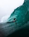 Person Surfing on Water Wave