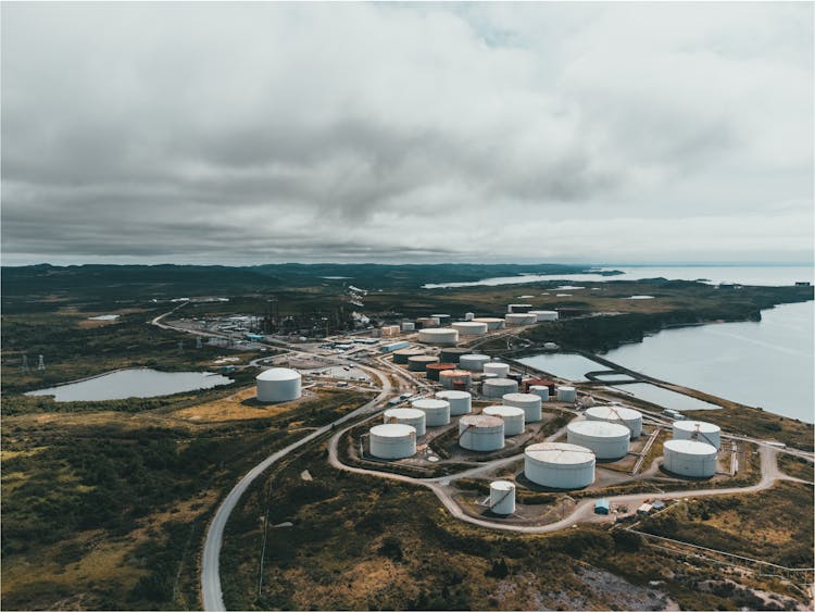 Oil Silos Near Body Of Water