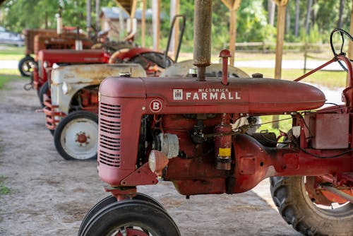 Abandoned Farm Tractors on Gray Sand