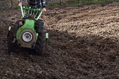 Man Using Small Plow on a Field