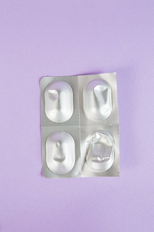 Free Medicine Packet on Purple Surface Stock Photo