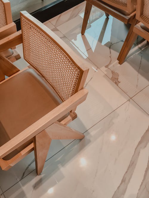 Free Brown Wooden Chair on Marble Floor Tiles Stock Photo