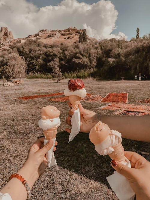 Hands Holding Ice Cream Cones 