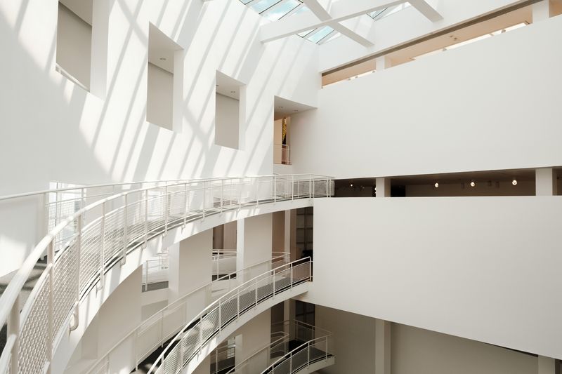 White atrium with curved balconies and skylights — photo by Airam Dato-on on Pexels