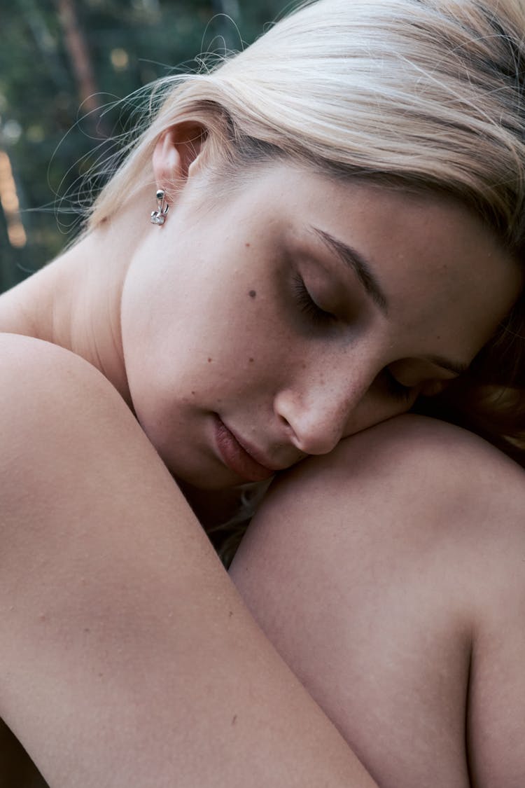 Woman With Blonde Hair Leaning Her Face On Her Knee