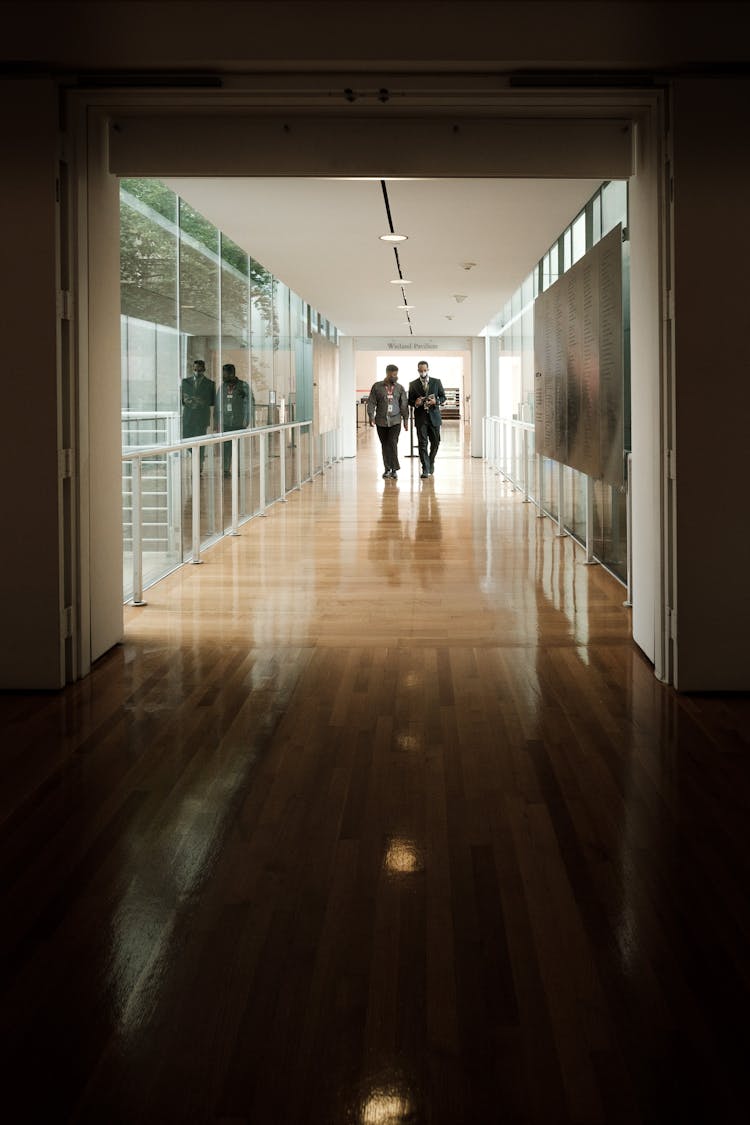 2 Workers Walking On The Hallway