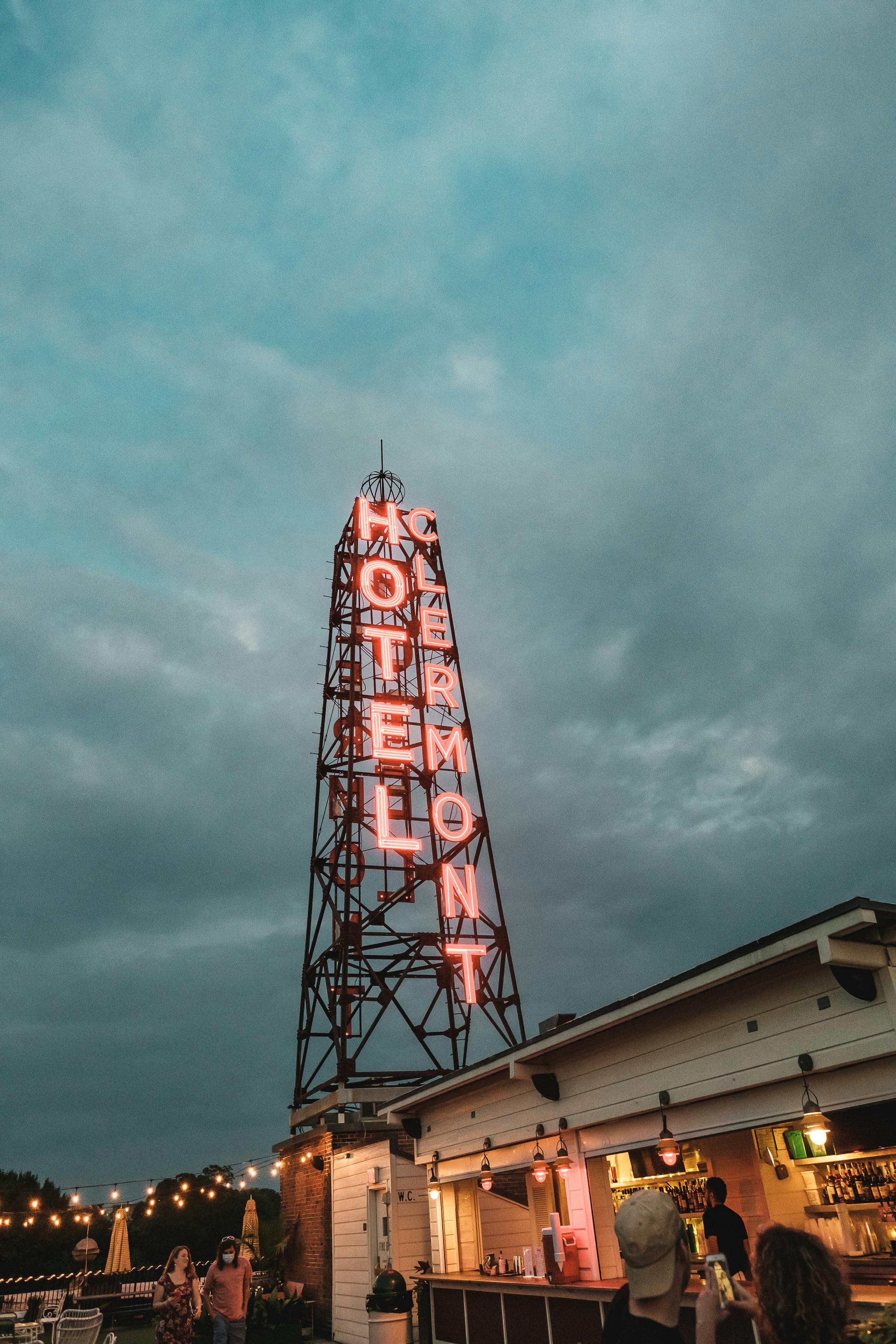 steel tower with neon hotel signage