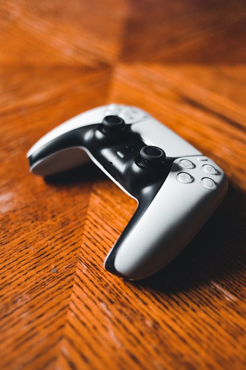 Free Game Console on a Wooden Surface  Stock Photo