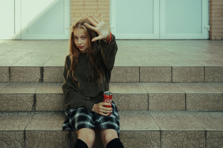 Woman In Skirt Holding A Coca Cola Can