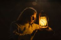 Woman Holding a Kerosene Lamp