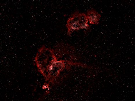 Capture the mesmerizing beauty of a cosmic nebula with vibrant colors amid a starry night.