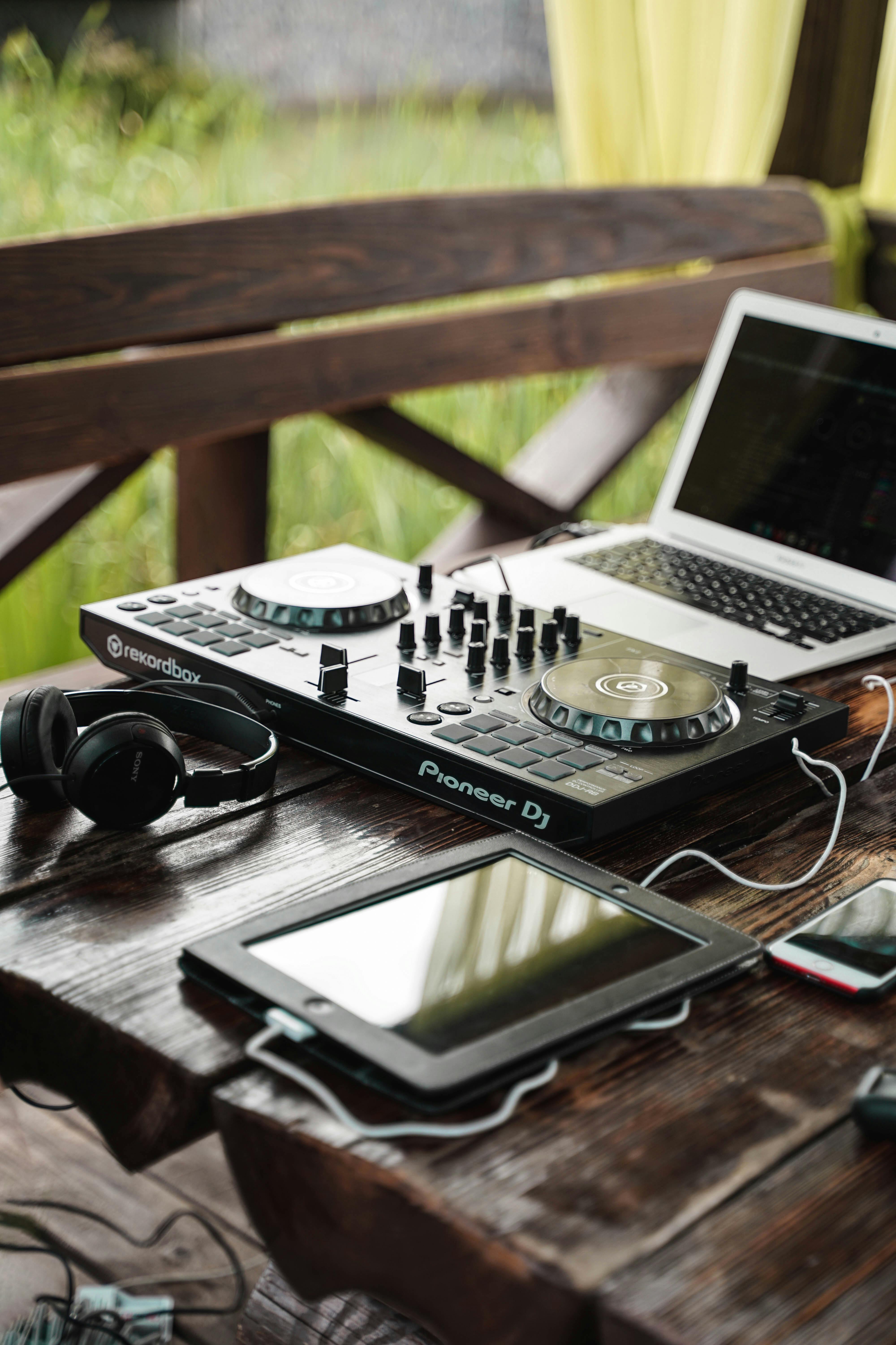A Turntable beside a Digital Tablet and a Laptop on a Wooden Table · Free Stock Photo