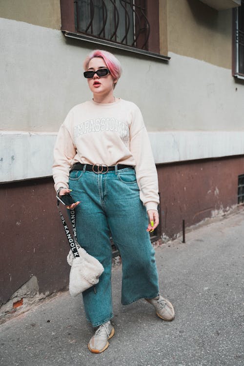 Woman in Pink Sweater and Denim Pants 