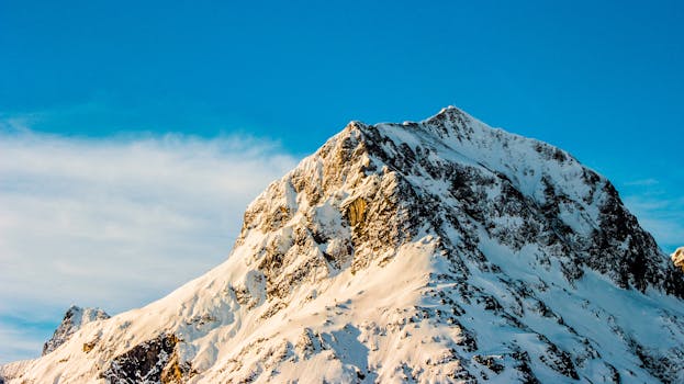 Stunning snow-covered mountain peak with clear blue sky in Lech, Austria.