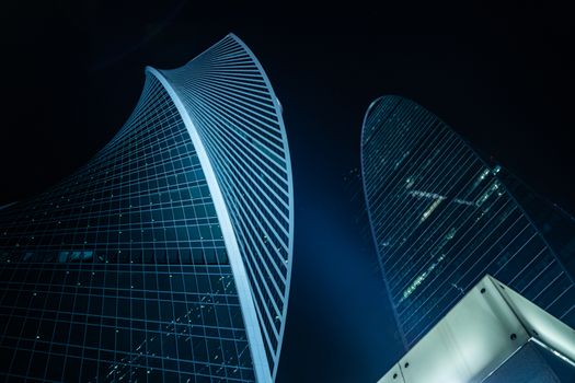 Stunning night view of modern skyscrapers showcasing architectural elegance and urban innovation.