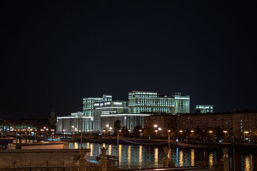 Stunning night scene of a landmark government building in Moscow, Russia, reflecting on the river.