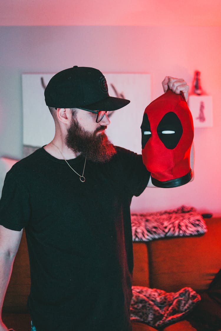 Man Holding A Deadpool Mask