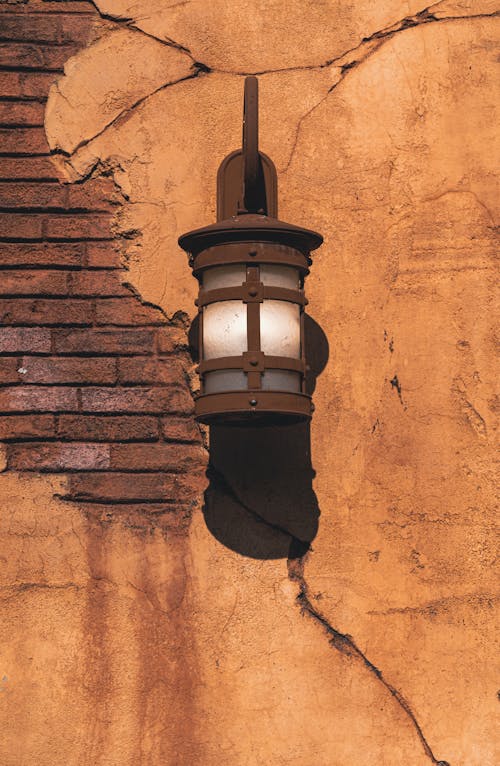 Brown Sconce Lamp on Brown Brick Wall