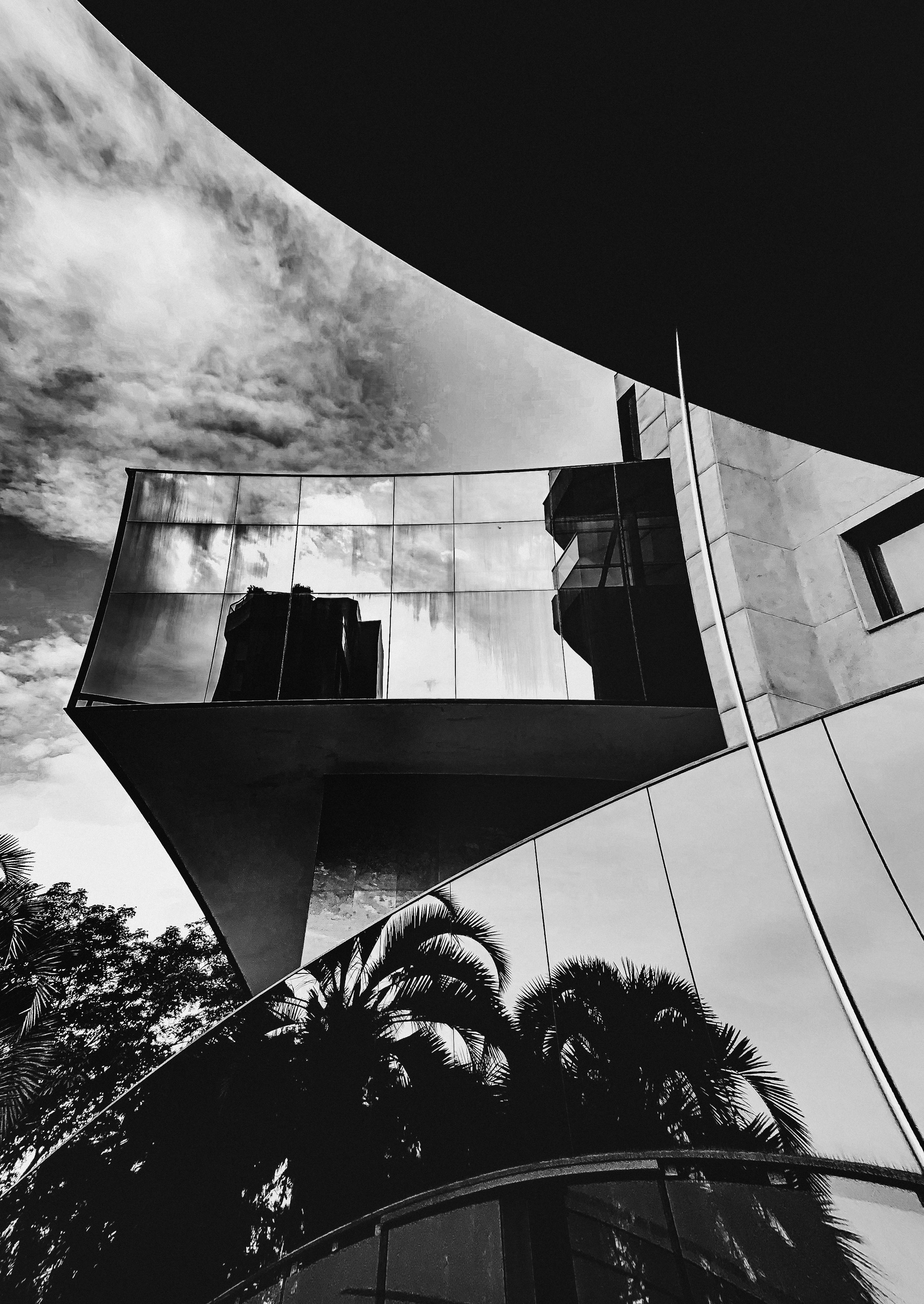 Abstract architectural shot capturing reflections in a modern glass building.