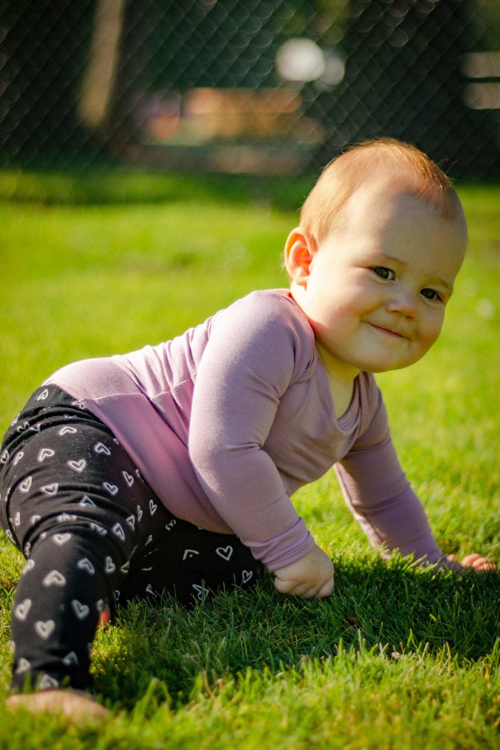 a kid sitting on the grass