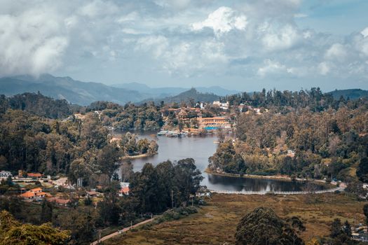 A beautiful aerial shot of Kodaikanal's lush landscape and serene lake surrounded by mountains.