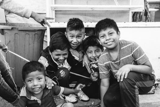 Five boys smiling and having fun outdoors in Ciudad de México, Mexico, creating a joyful and playful moment.