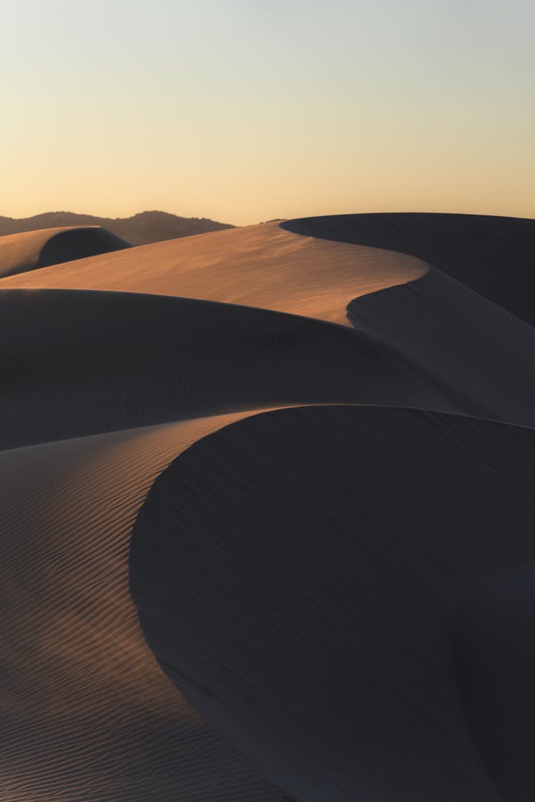 Brown Sand Dunes During Sunset