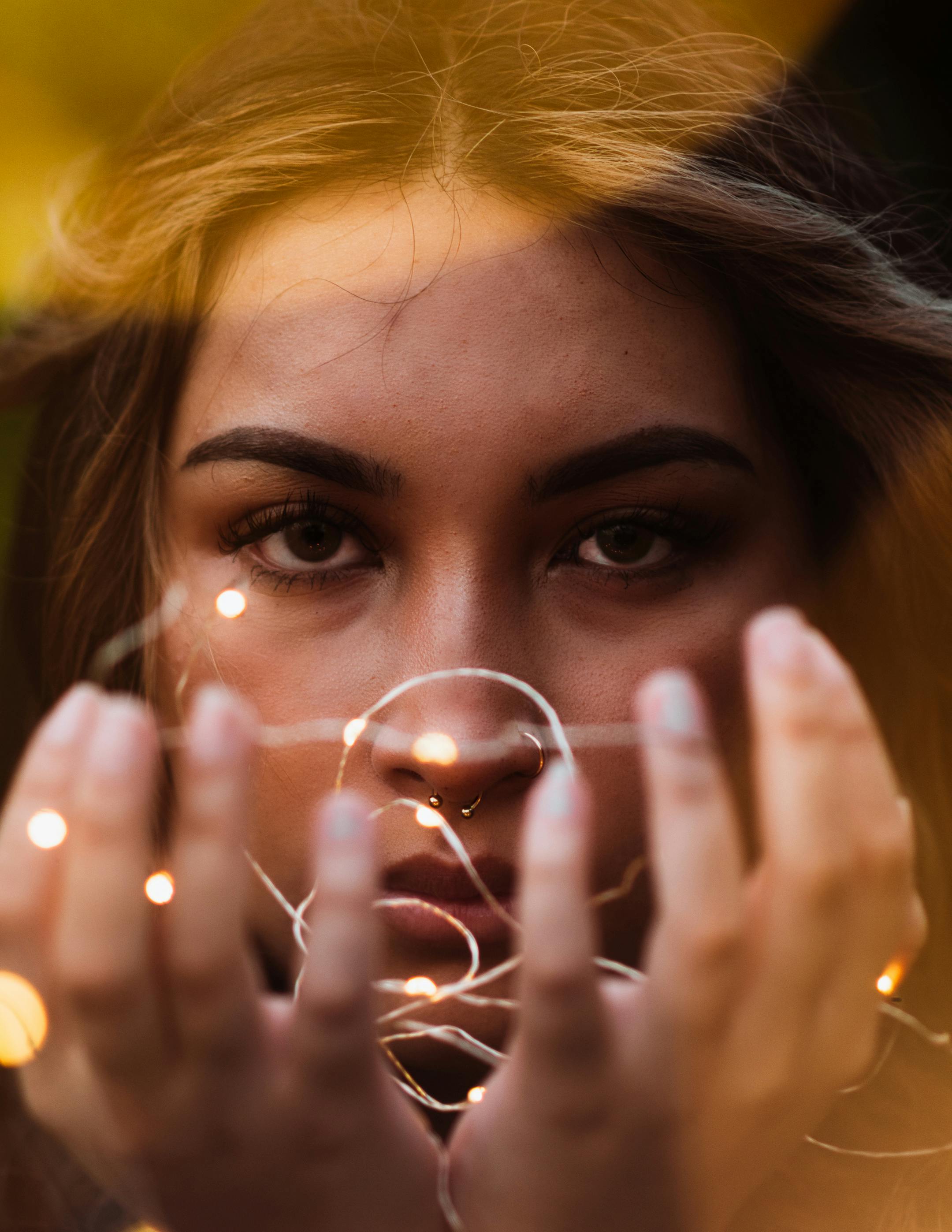 Selective Focus Photography of Man Standing Behind String Lights · Free