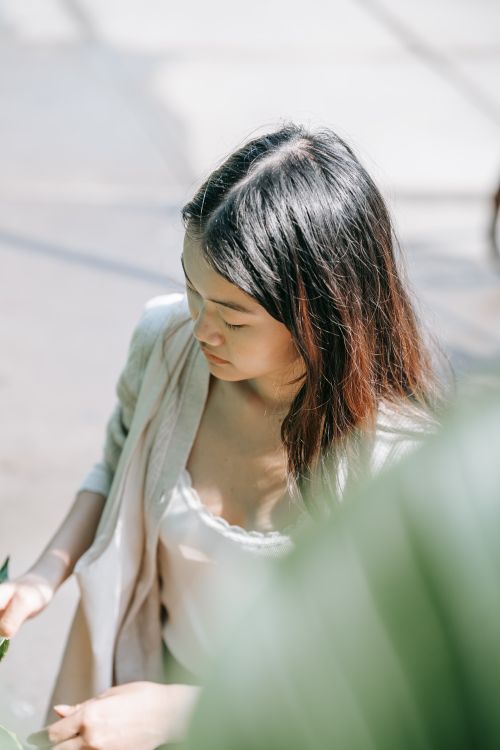 Free Young woman enjoying the outdoors with soft natural lighting. Stock Photo