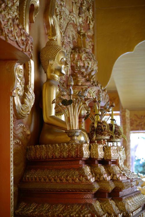 Free Close-up of a golden Buddha statue on an ornate altar, highlighting intricate details. Stock Photo
